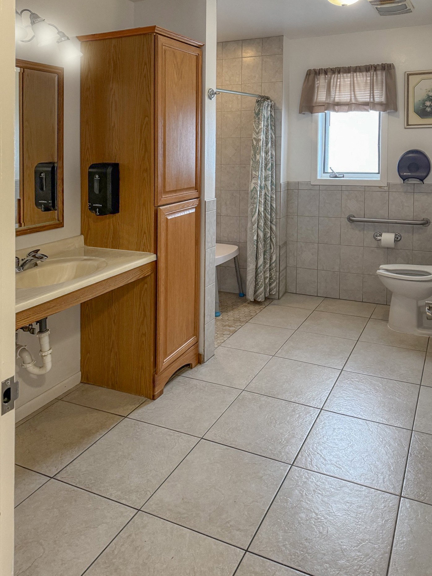 A bathroom with a sink, toilet, and shower.